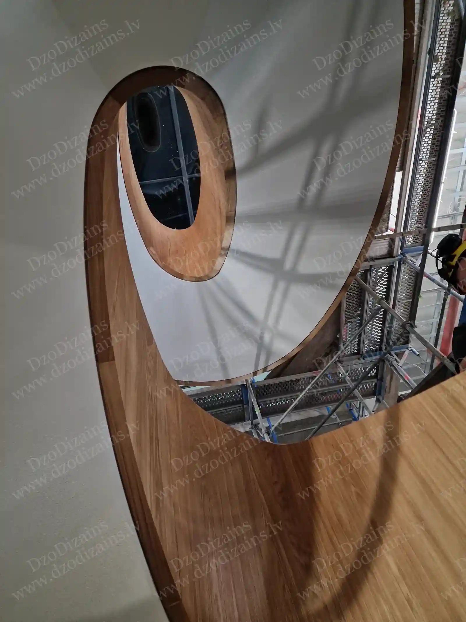 Большая деревянная лестница с выраженным изгибом на стройплощадке